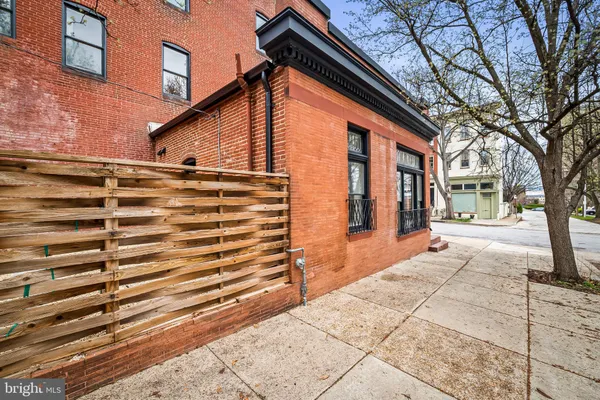 a backyard of a house with oven and trees