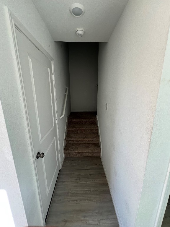 520 Commander Abbott Drive Jarrell, TX 76537 - Photo 5 of 25 a view of staircase with wooden floor and white walls