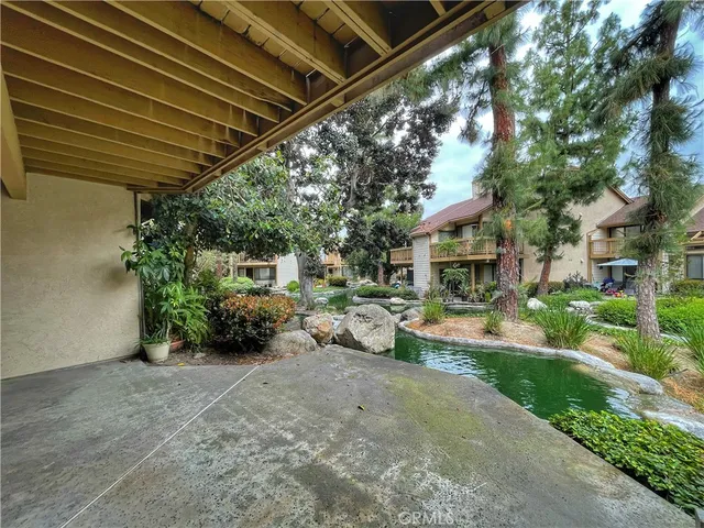a view of a patio with table and chairs and potted plants