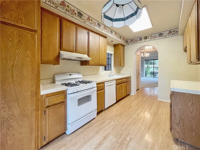 a kitchen with a stove window and cabinets