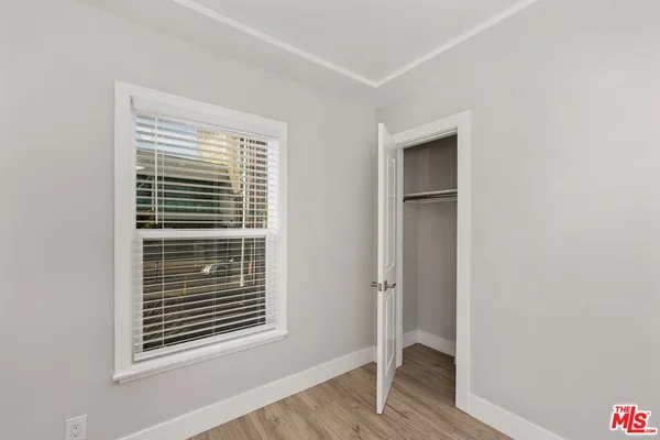 a kitchen with granite countertop a sink a counter top space stainless steel appliances and cabinets