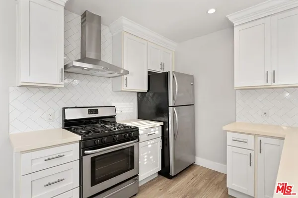 a kitchen with a sink cabinets and window