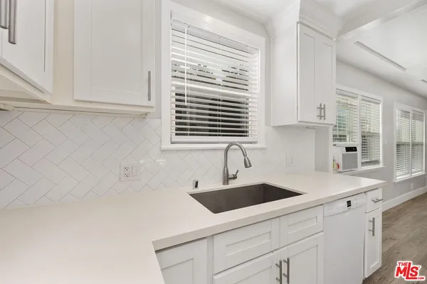 a kitchen with granite countertop a stove and a sink