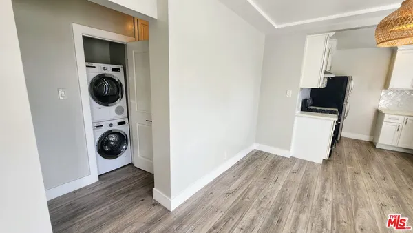 a view of a hallway with washer and dryer