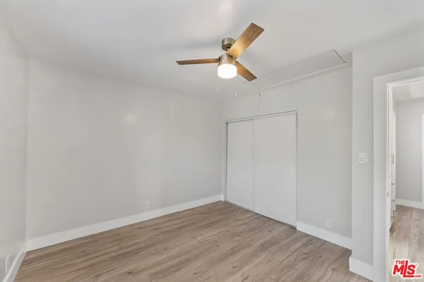 a bathroom with a granite countertop sink toilet a mirror and shower