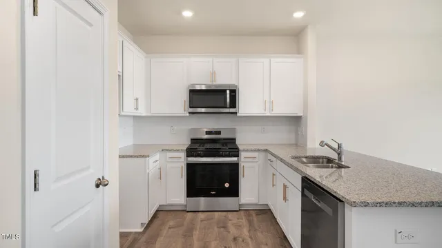 a kitchen with stainless steel appliances granite countertop a stove and a sink