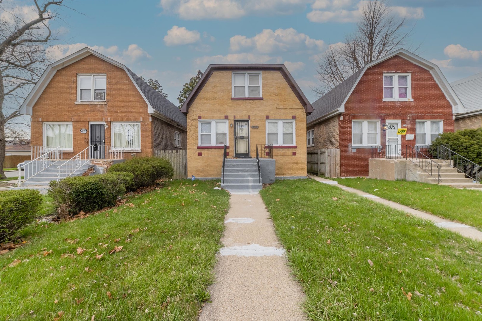 9154 South May Street Chicago, IL 60620 - Photo 1 of 12 a front view of a house with a garden and yard
