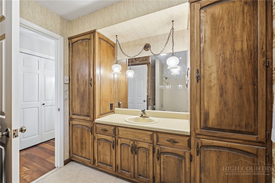 304 Glendale Drive Boone, NC 28607 - Photo 29 of 50 a bathroom with a double vanity sink and mirror with shower