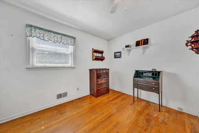 a reading room with furniture and a window