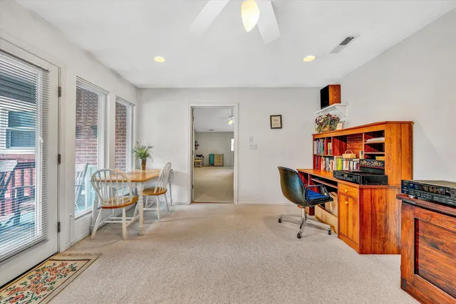 a view of a backyard with furniture and garden