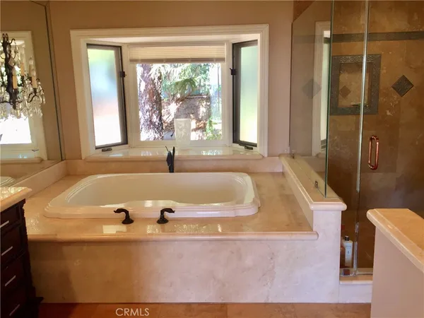 a bath tub sitting in a bathroom next to a window