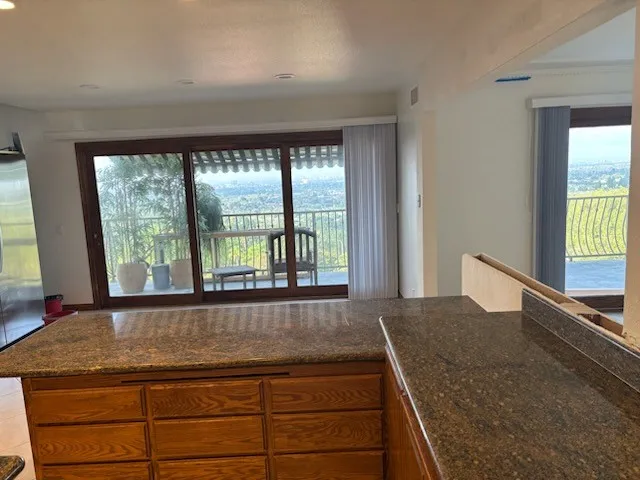 a view of a kitchen counter top space with furniture and staircase