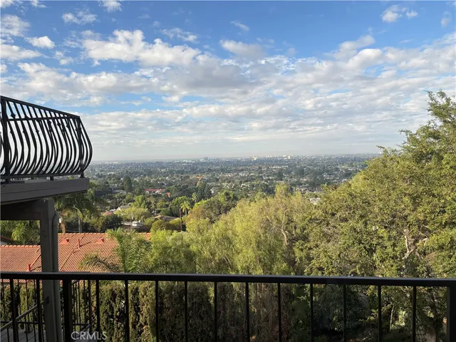 a view of a balcony with wooden fence