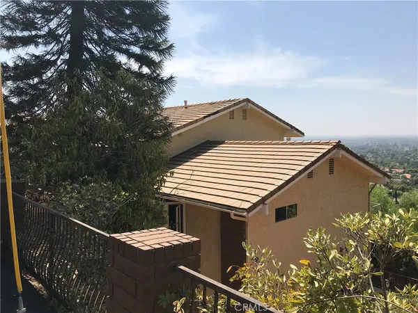 a front view of a house with plants