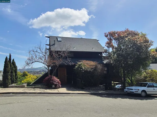 a view of a yard of the house and cars parked