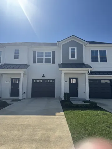 a view of a house with a garden and yard