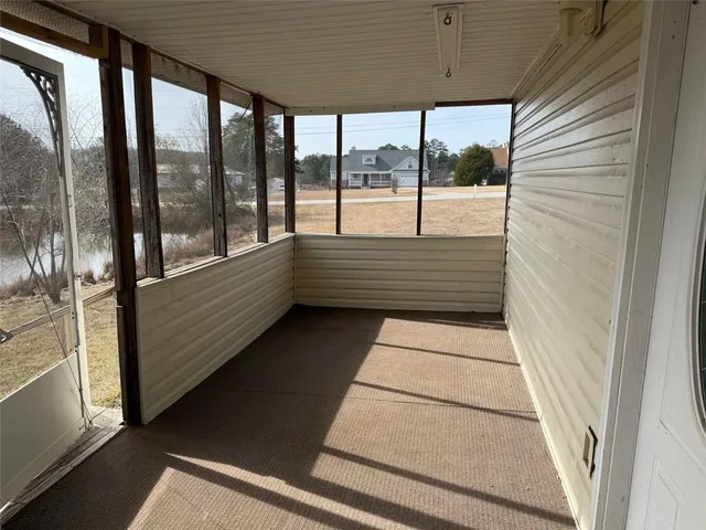 a kitchen with wooden floors and refrigerator