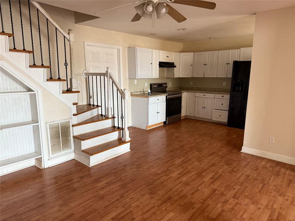 149 Woody Road Jackson, GA 30233 - Photo 6 of 17 a kitchen with wooden floors and refrigerator