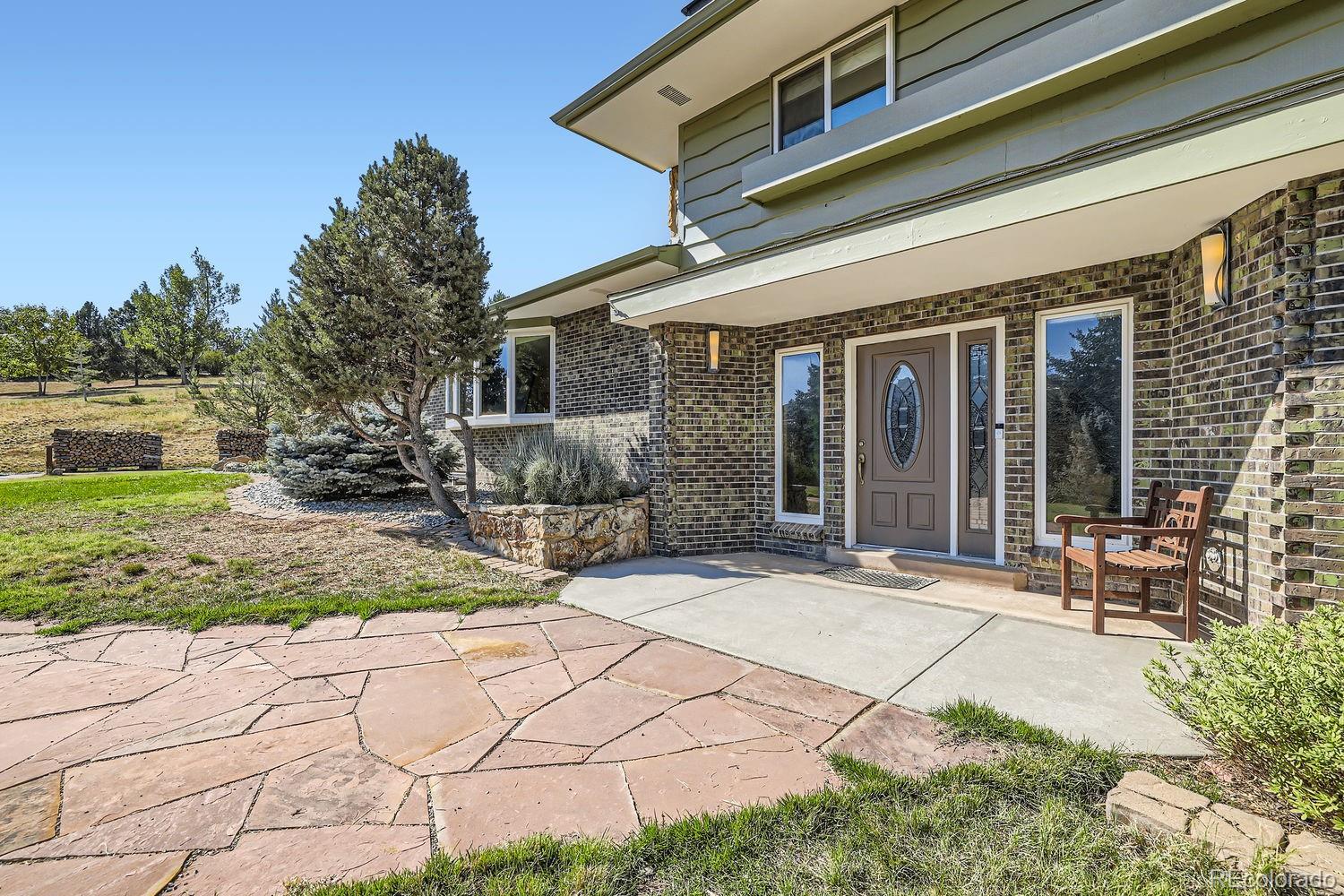 6227 Colorow Drive Morrison, CO 80465 - Photo 3 of 43 a backyard of a house with yard and outdoor seating