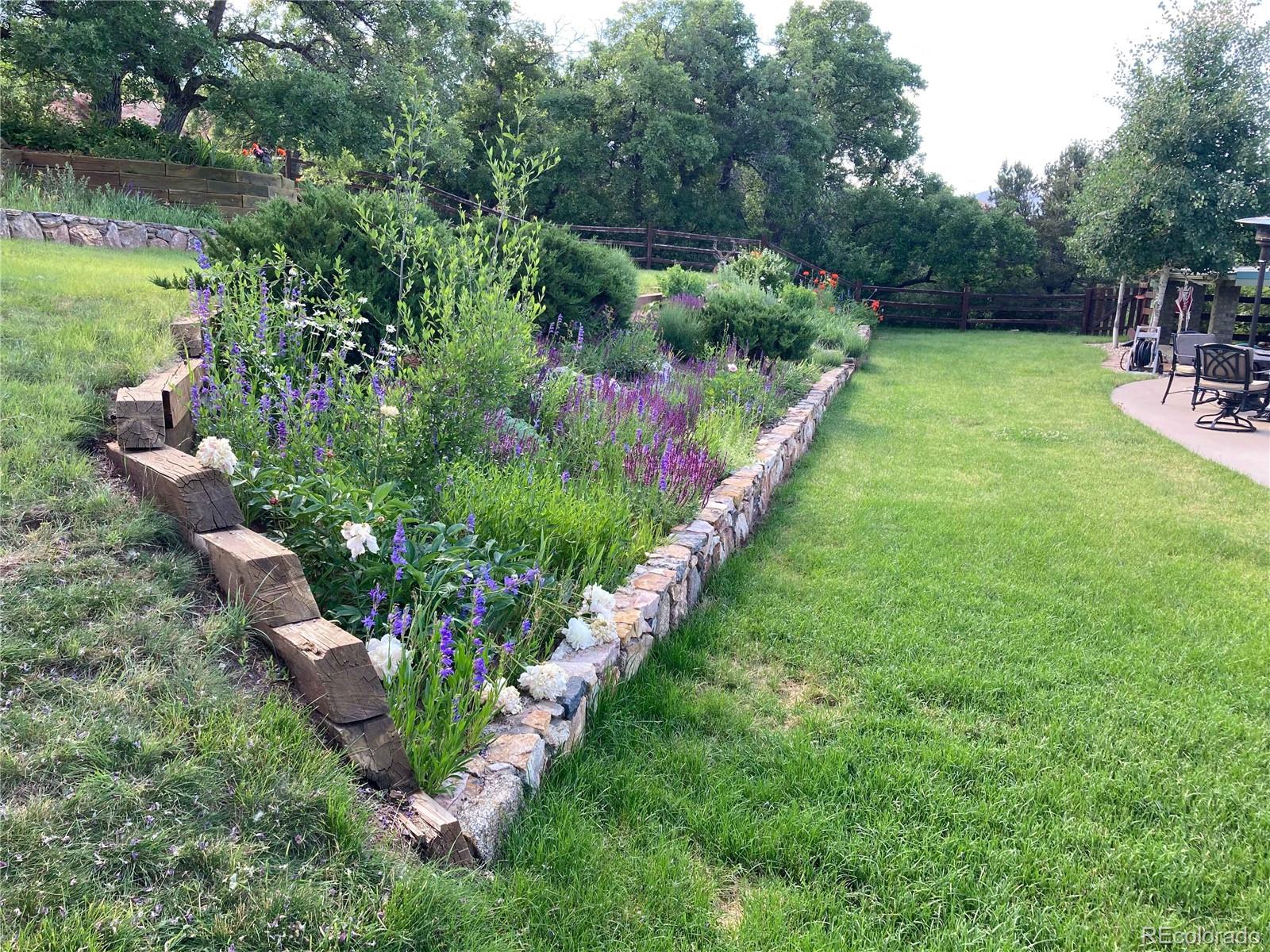 6227 Colorow Drive Morrison, CO 80465 - Photo 36 of 43 a view of a garden with a lake
