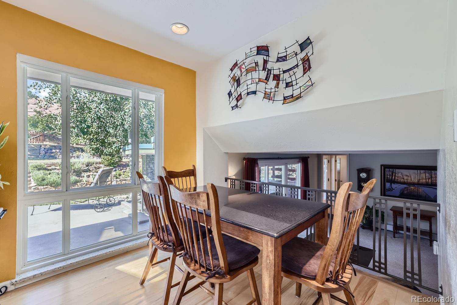 6227 Colorow Drive Morrison, CO 80465 - Photo 10 of 43 a view of a dining room with furniture window and wooden floor