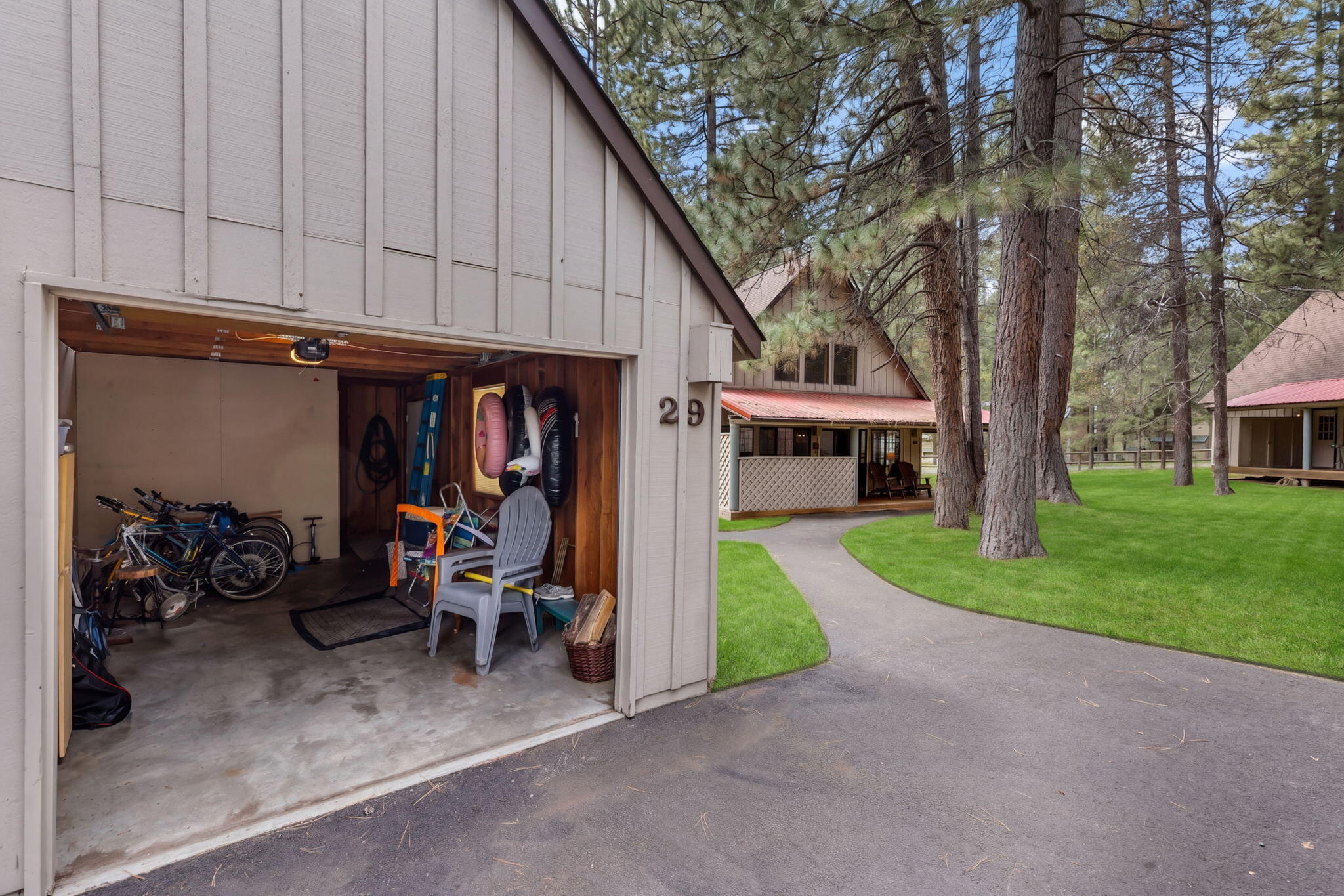 57505 Circle 4 Cabin Road, Unit 29 Sunriver, OR 97707 - Photo 29 of 35 a view of a house with a patio and a car parked beside a road
