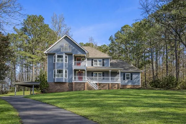 a front view of a house with a garden