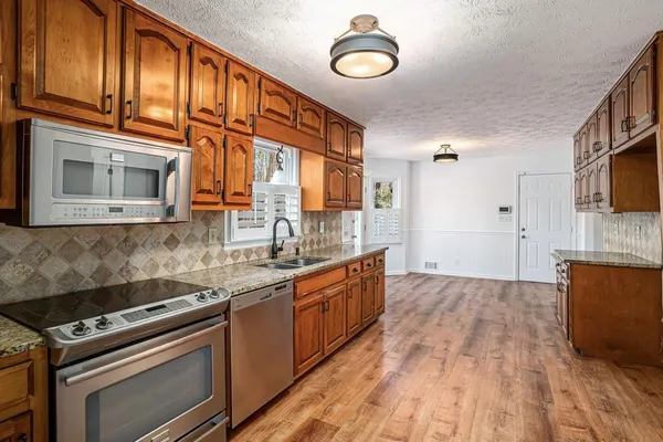 a kitchen with stainless steel appliances granite countertop a stove and a sink