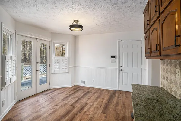 a bedroom with a bed and wooden floor