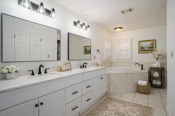 a bathroom with bathtub and window
