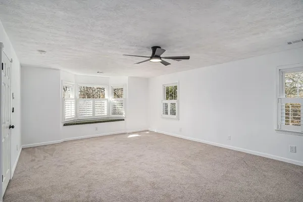 a view of empty room with windows