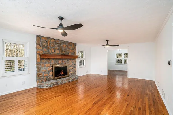 a view of a dining room with furniture a chandelier and wooden floor