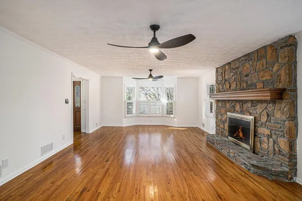 a view of a room with wooden floor and a window