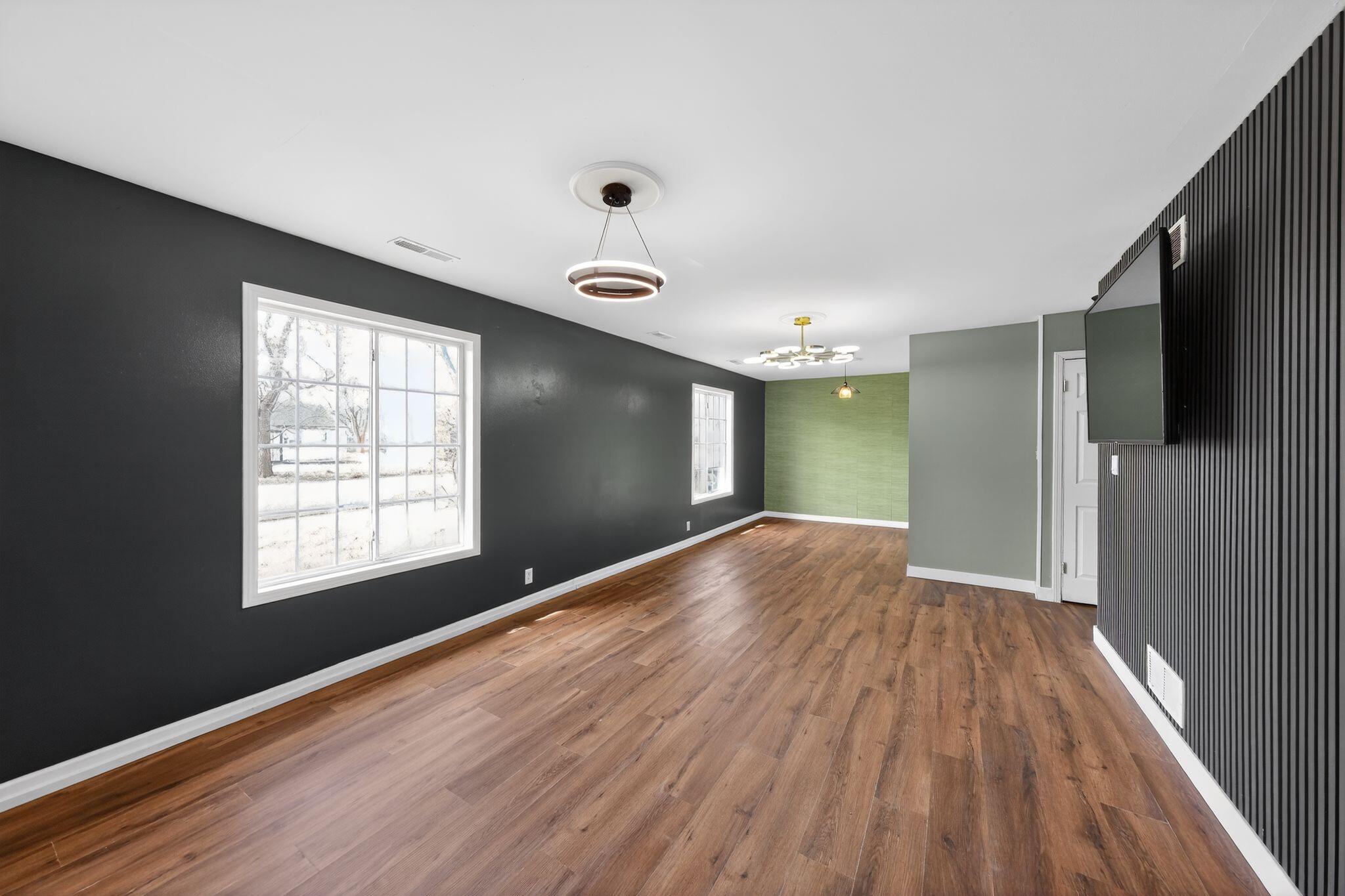 1908 Central Drive Gary, IN 46407 - Photo 11 of 29 a view of an empty room with wooden floor and a window