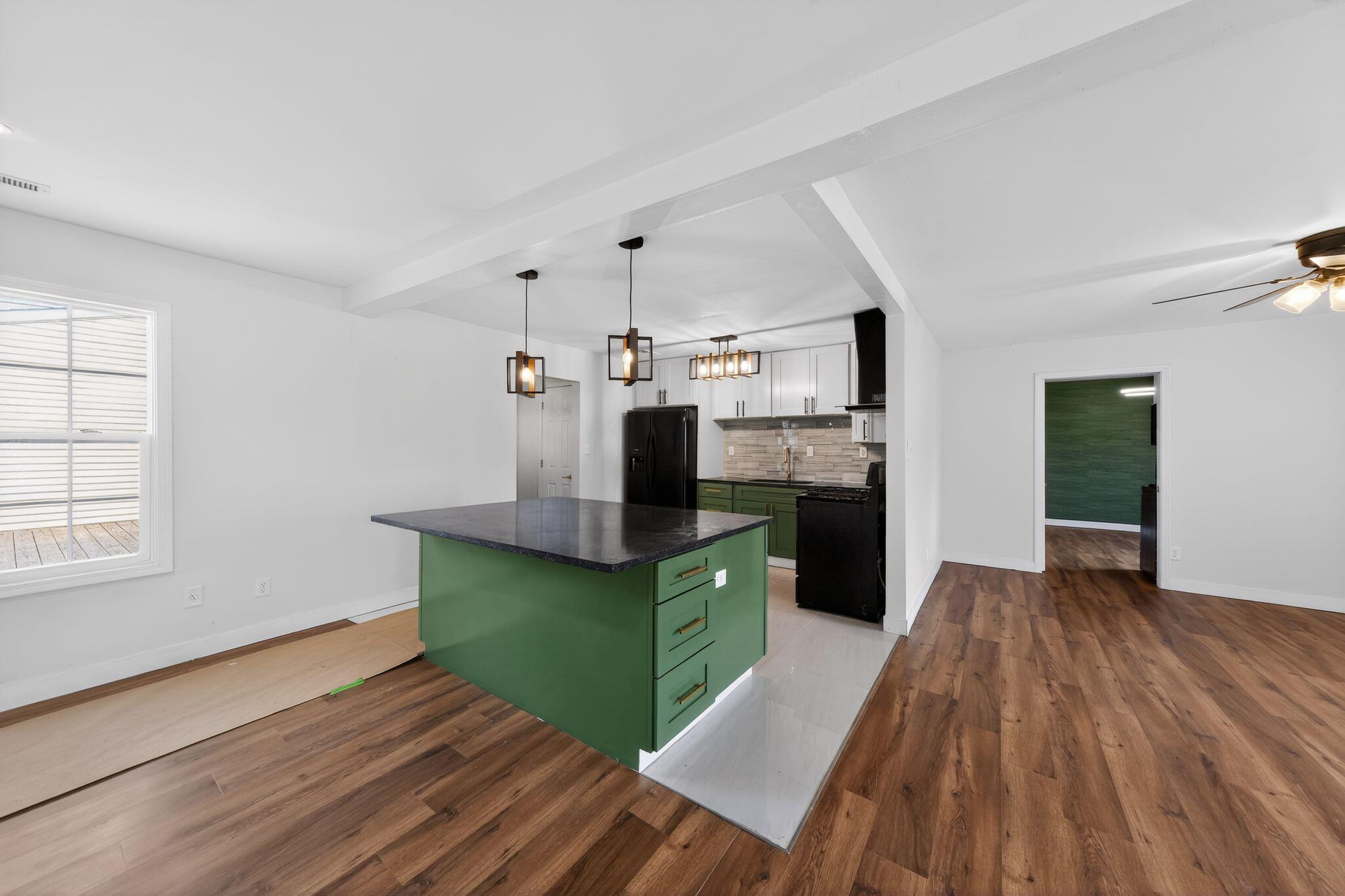1908 Central Drive Gary, IN 46407 - Photo 7 of 29 a kitchen with kitchen island stainless steel appliances a sink cabinets and wooden floor