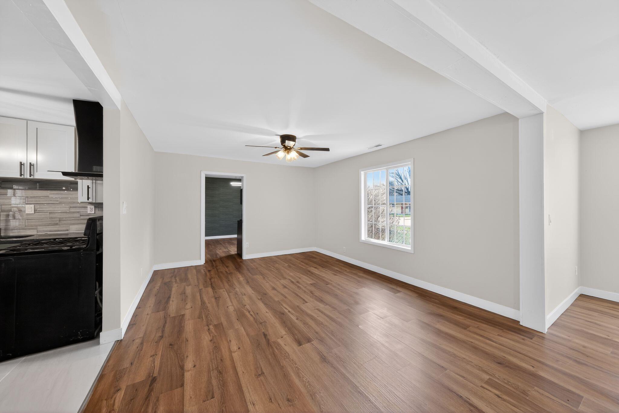 1908 Central Drive Gary, IN 46407 - Photo 10 of 29 a view of empty room with wooden floor and kitchen