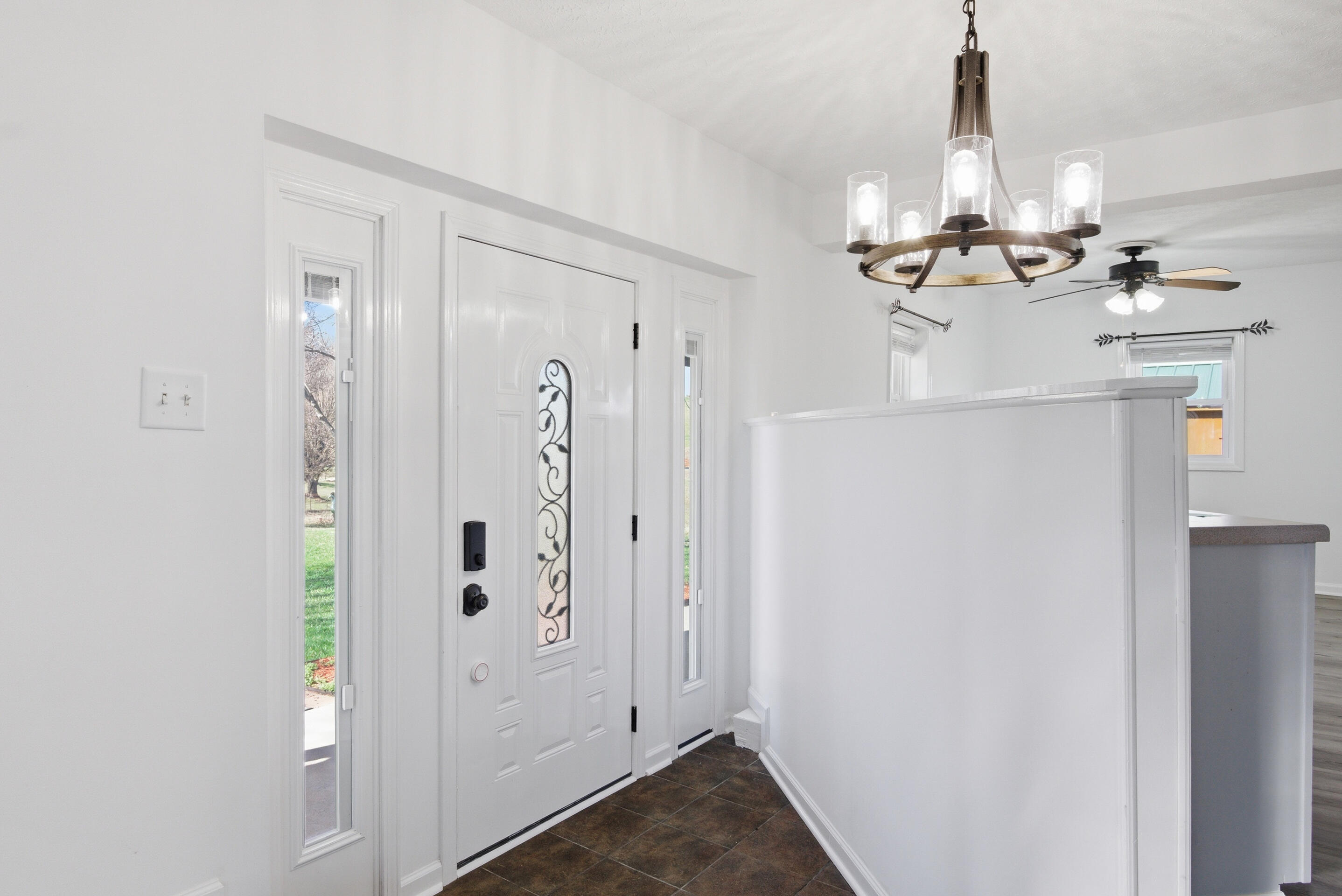 6458 Piney Woods Road Riner, VA 24149 - Photo 2 of 50 a view of a hallway with chandelier and refrigerator