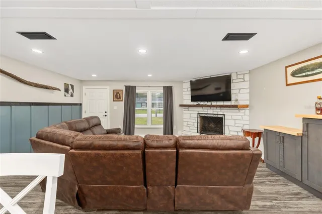 a living room with furniture a fireplace and a flat screen tv