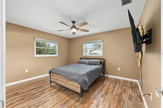 a bedroom with a bed and a chandelier