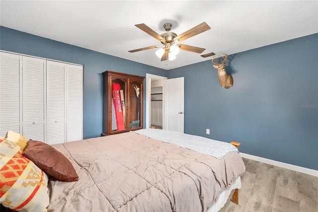 a bedroom with a large bed and a chandelier