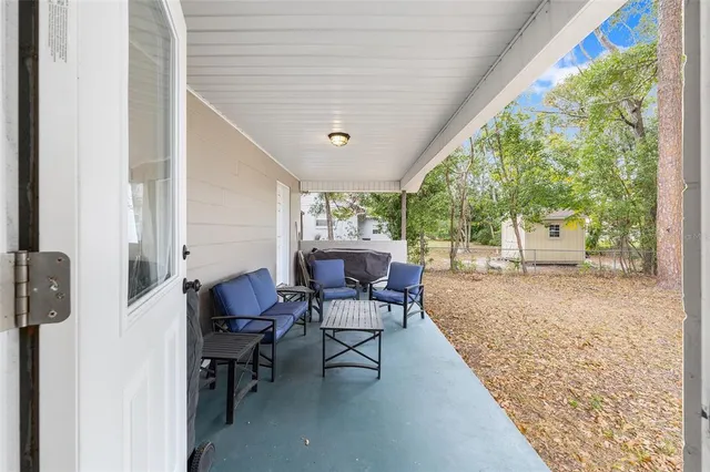 a view of a patio with table and chairs and potted plants