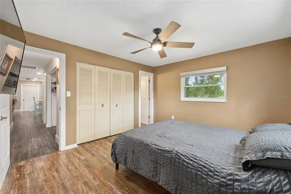 a bedroom with a large bed and a chandelier