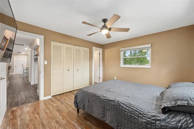 a bedroom with a large bed and a chandelier
