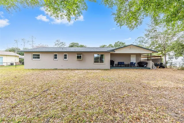 a front view of a house with a garden and tree