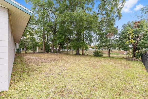 a backyard of a house with large trees