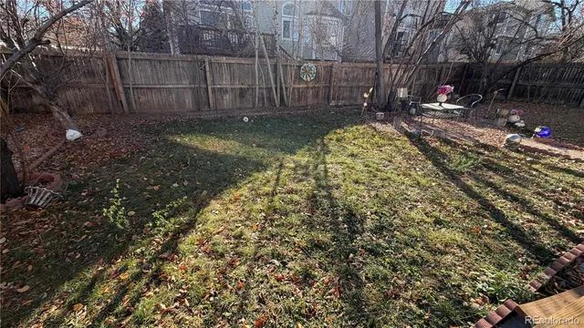 a view of yard with wooden fence