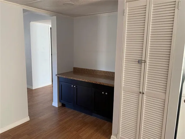 a view of kitchen and wooden floor