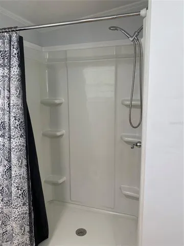 a bathroom with a glass shower door