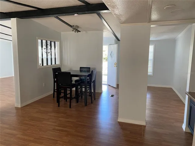 a view of a dining room with furniture and wooden floor