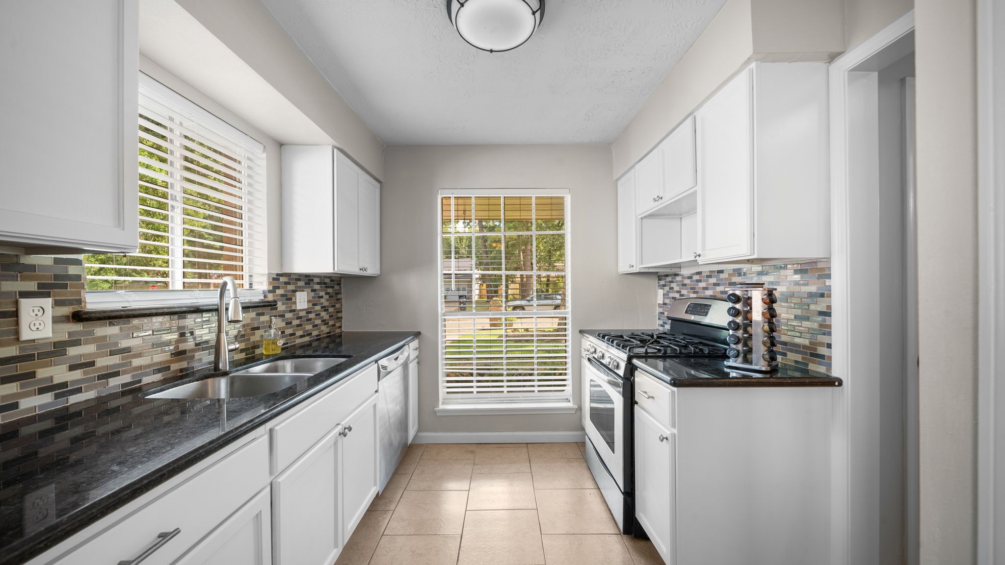 9631 Crail Drive Spring, TX 77379 - Photo 14 of 29 Kitchen with granite countertops and gas range